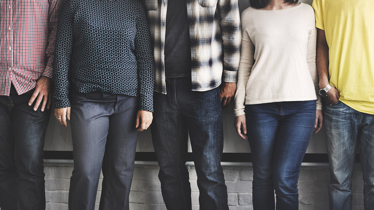 5 people standing next to each other showing off clothing