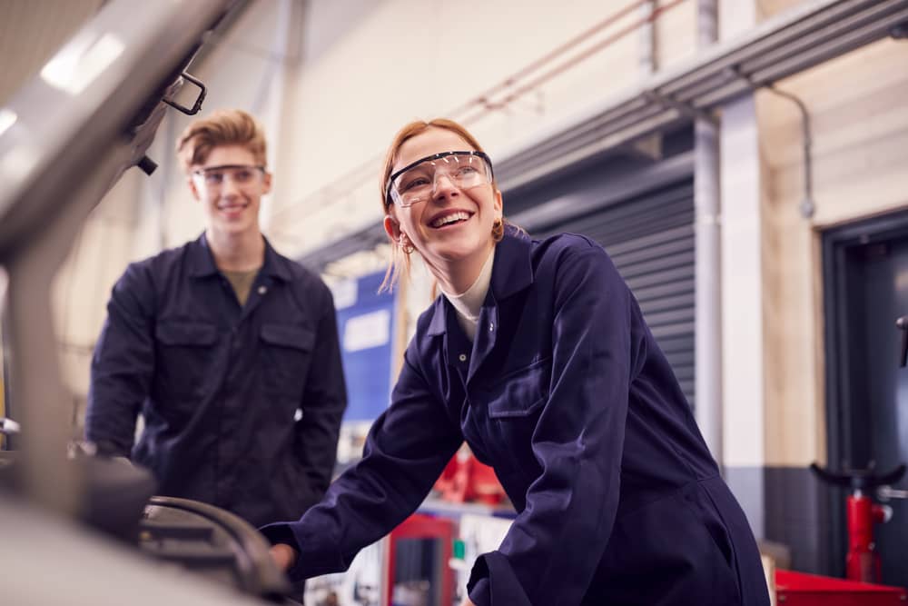 Two junior engineers work on something.