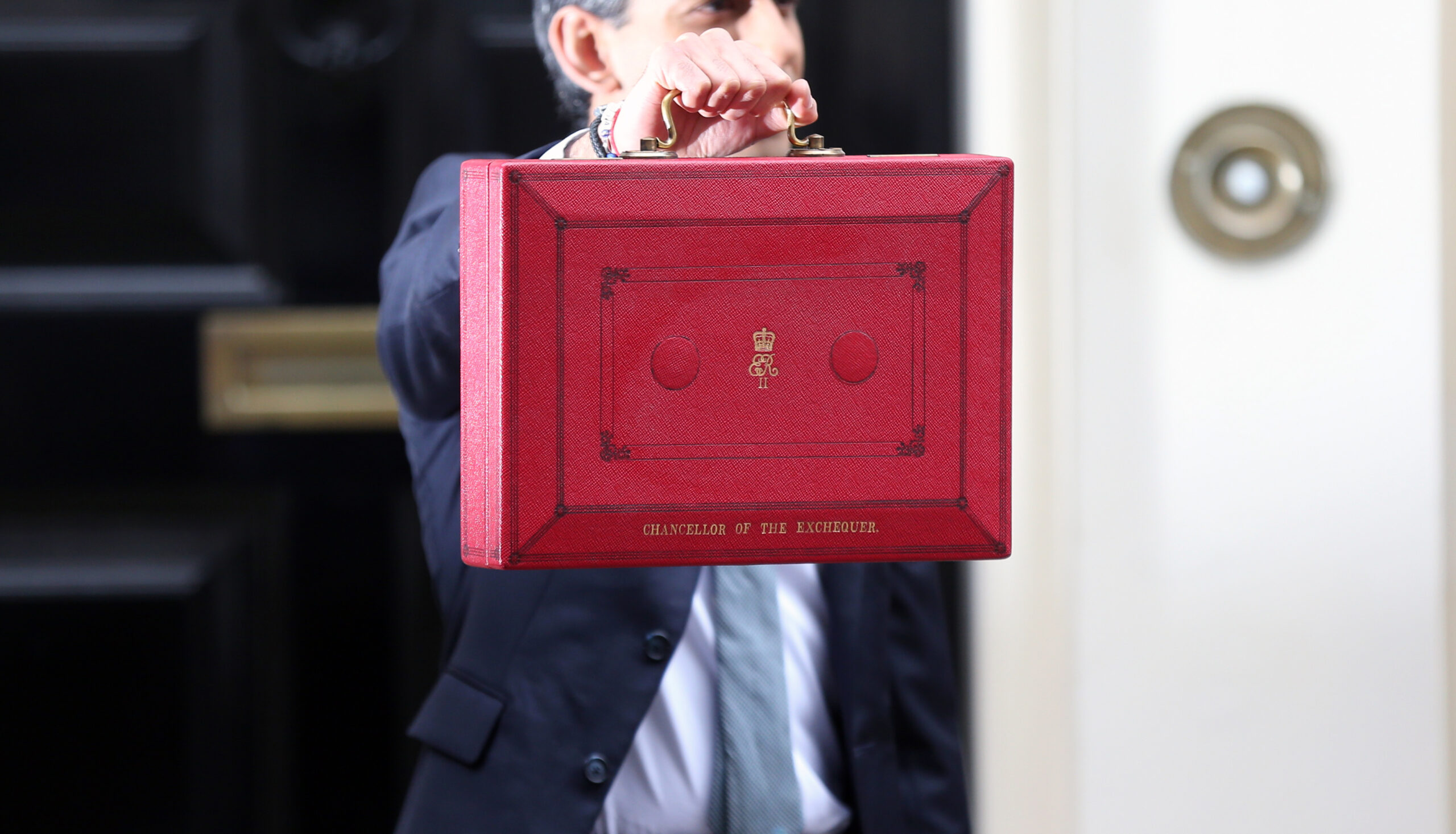 Chancellor hold red dispatch box up.
