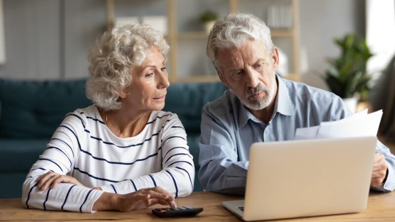 Two older people budget their pension.