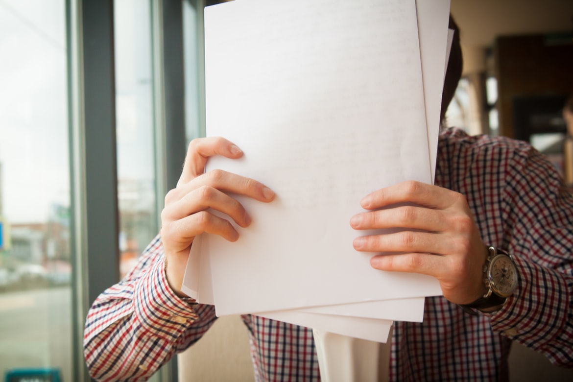 A man organises paper.