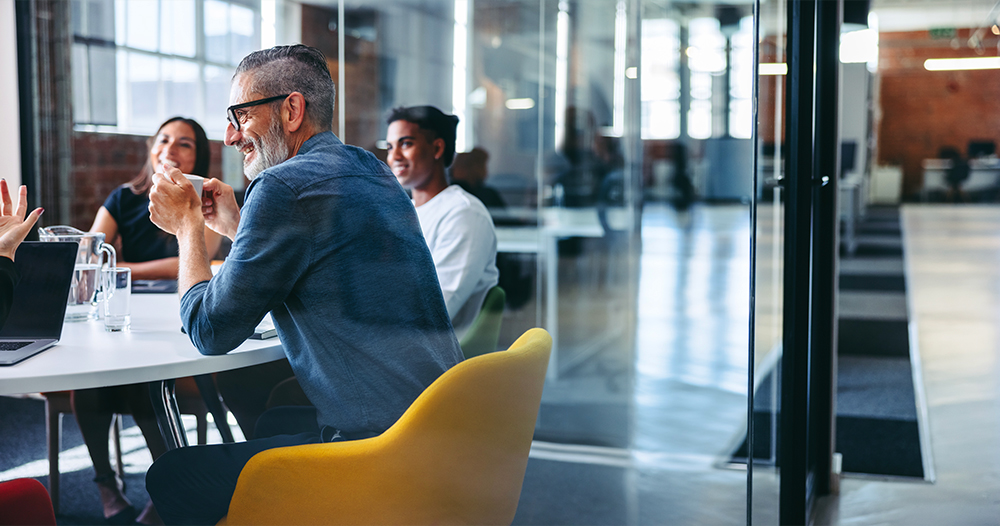 team of people sitting in office talking