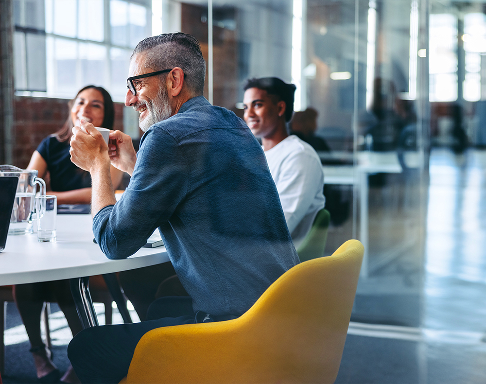 team of people sitting in office talking