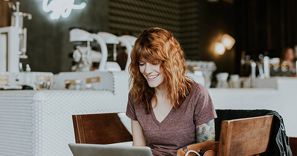 woman smiling looking at laptop