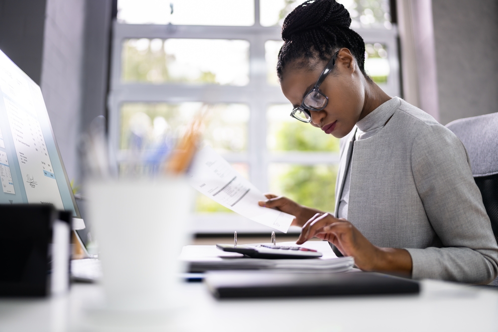 African,American,Accountant,Or,Auditor,With,Calculator