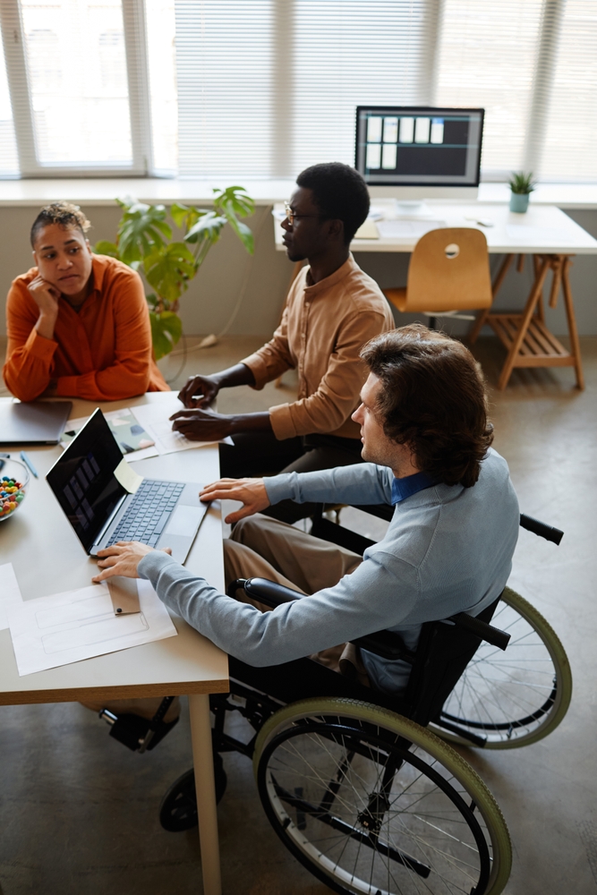 Vertical,Portrait,Of,Diverse,Business,Team,Discussing,Project,At,Meeting