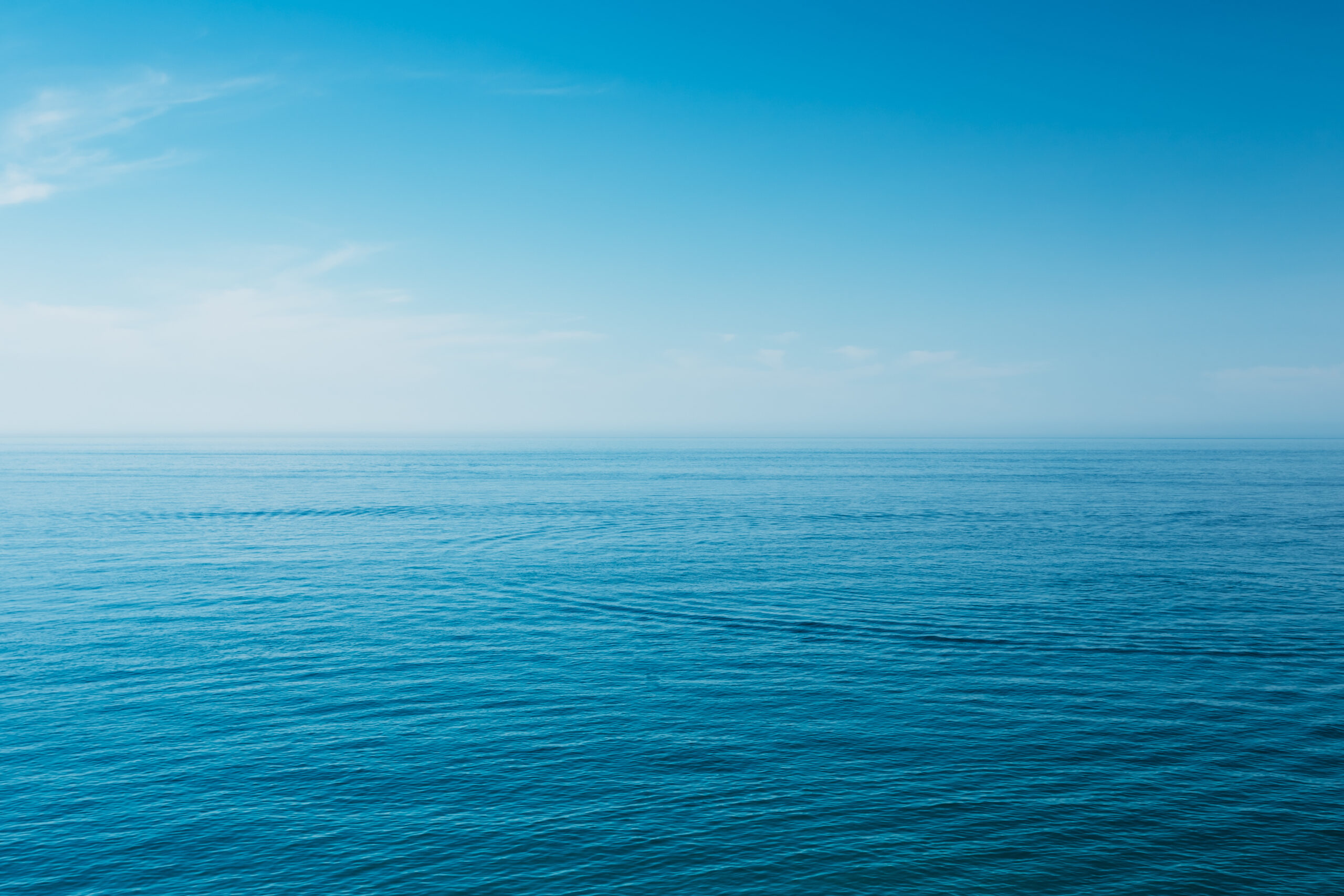 Calm,Sea,Ocean,And,Blue,Sky,Background