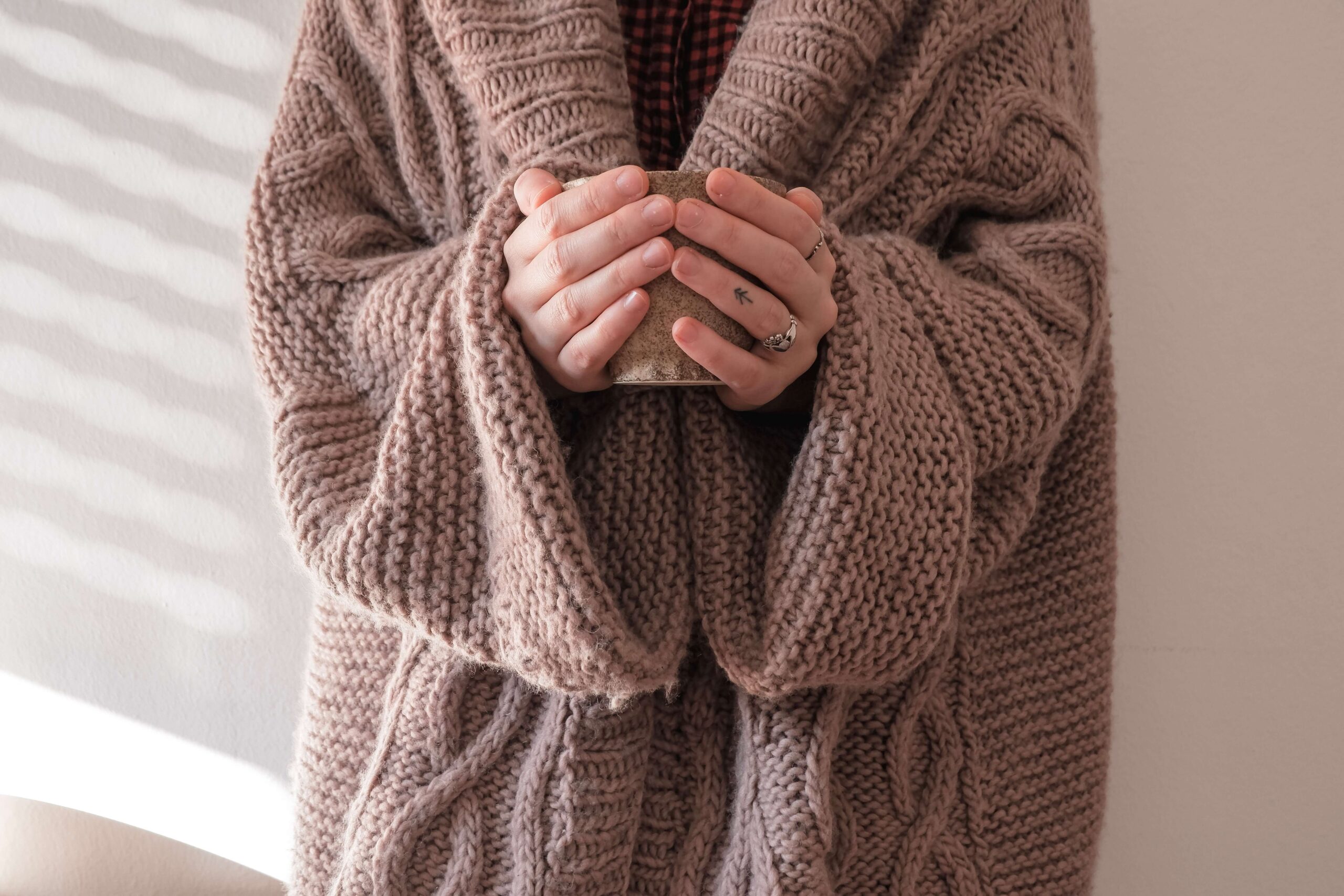 woman cold at home representing high energy bills