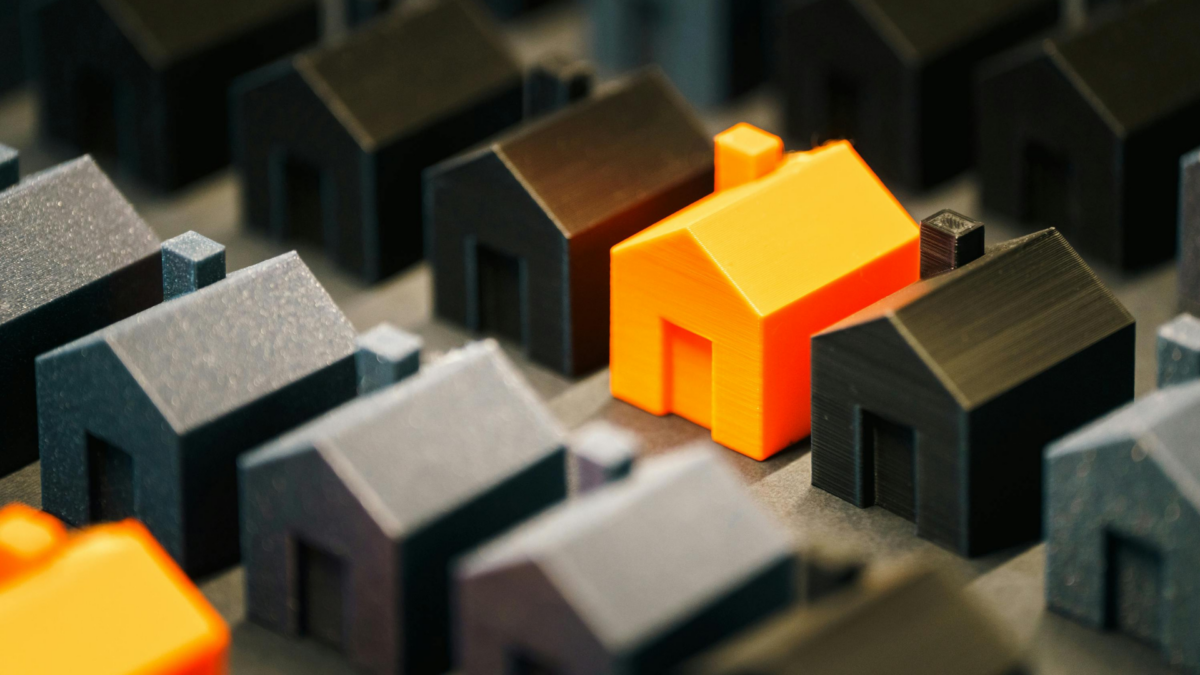 CGI graphic showing rows of black houses and occasional orange houses