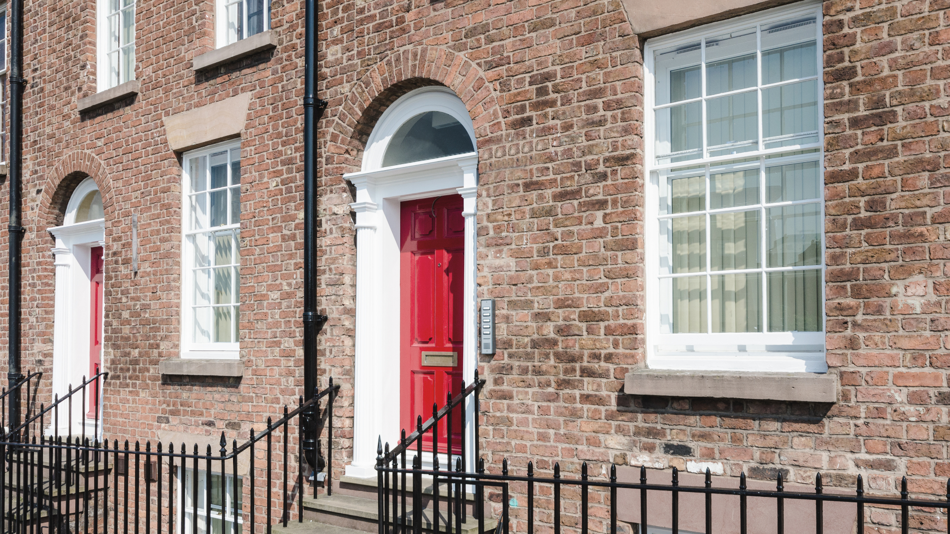 Image of a Georgian house in Liverpool with a red door and mutli-access intercom