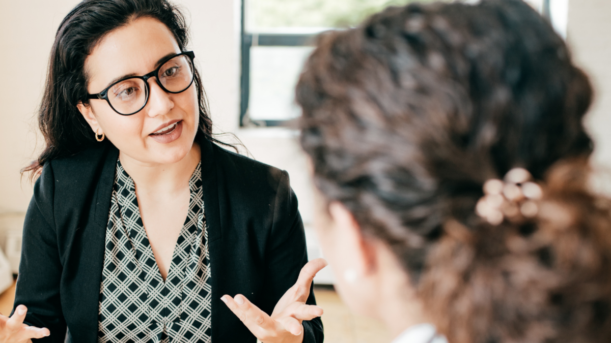 Two female business people having a discussion in an office